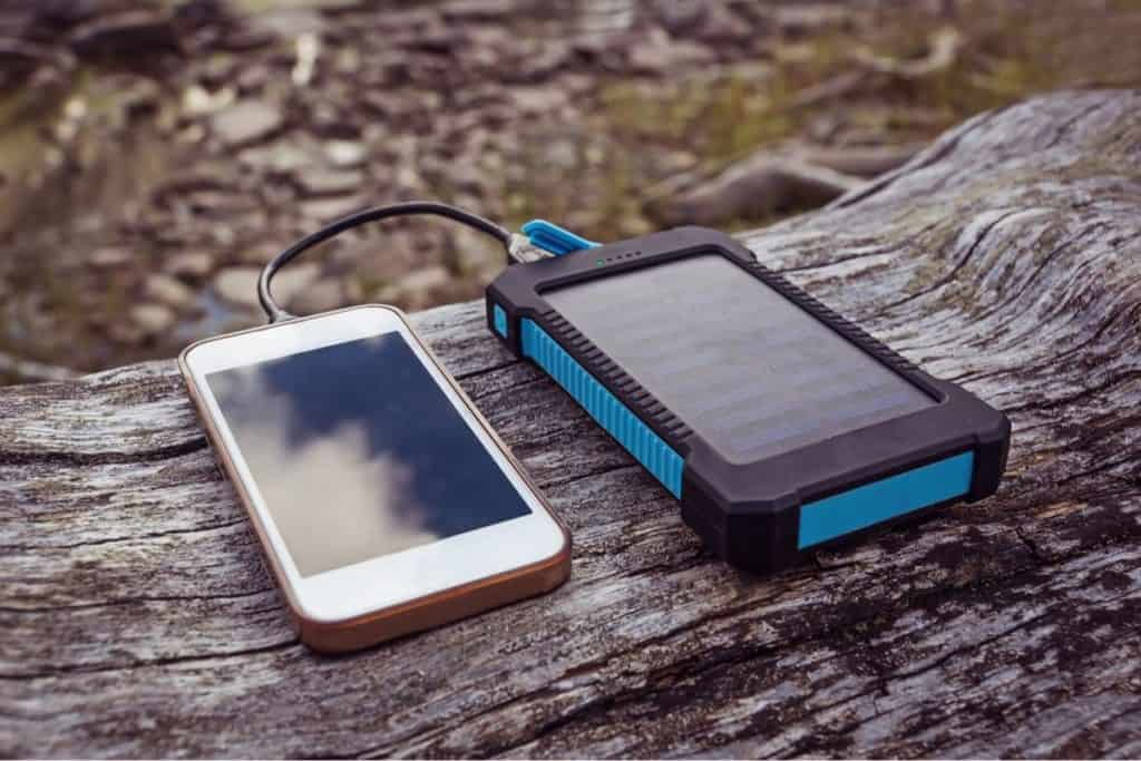 Cell phone being charged by a solar phone charger