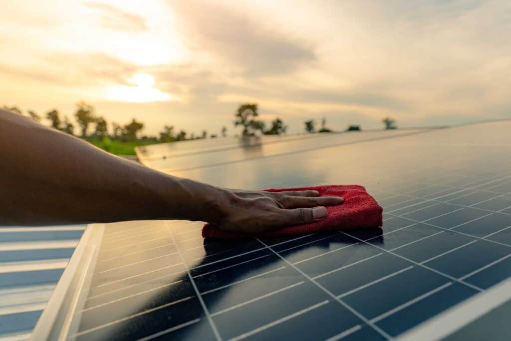 Hand cleaning a solar panel