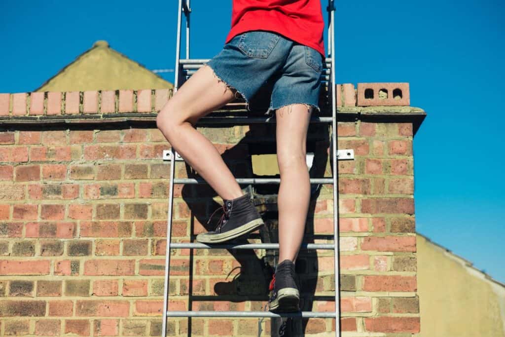 Climbing a ladder onto a house roof