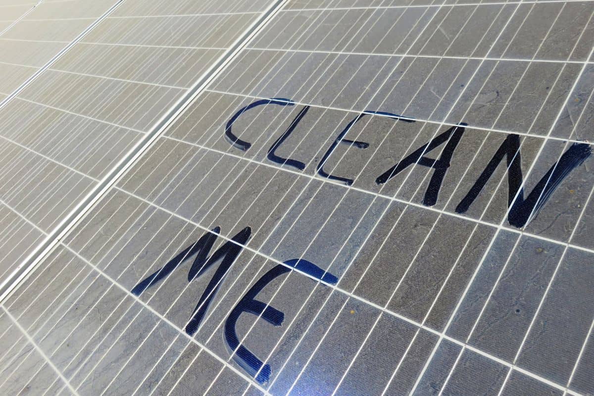 Dusty Solar panels that have clean me written on them