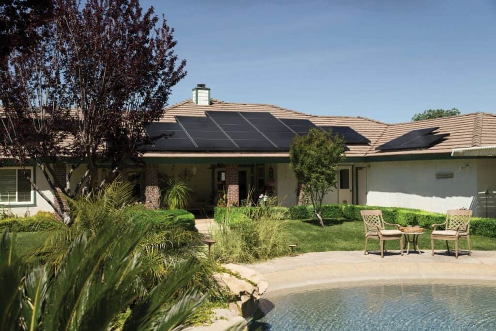 Solar panels on a house roof that are powering a pool pump